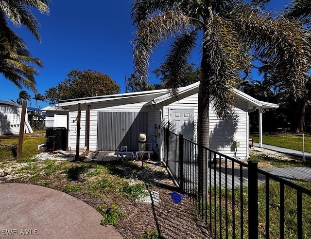 view of outbuilding with fence