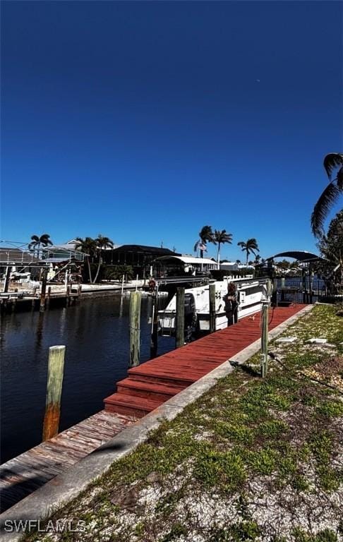 dock area with a water view and boat lift