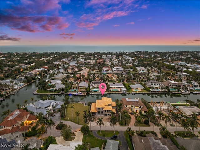 drone / aerial view featuring a water view and a residential view