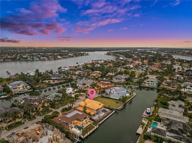 aerial view at dusk with a water view