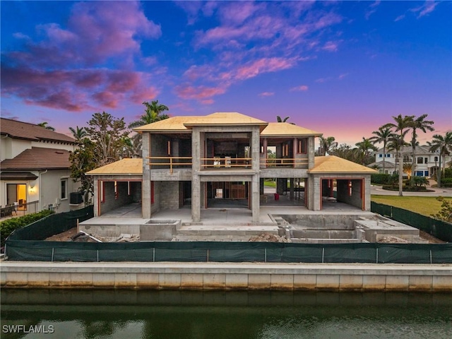 back of house featuring a patio area, a water view, and a balcony