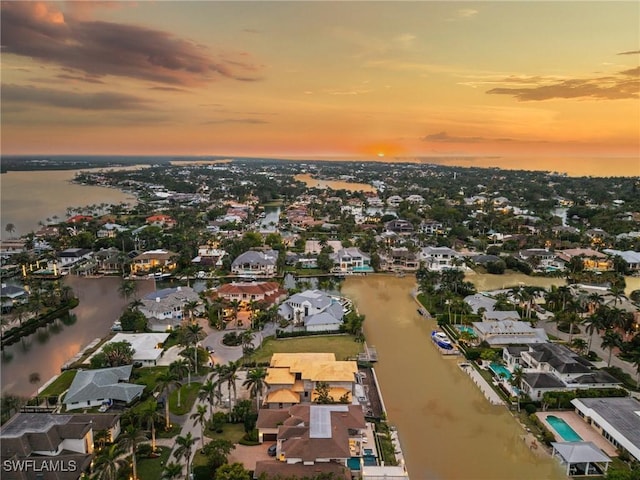 birds eye view of property with a water view and a residential view