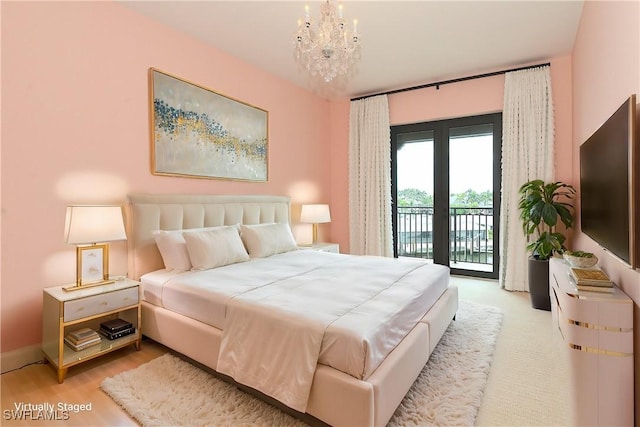 bedroom featuring a chandelier, baseboards, light wood-style floors, access to outside, and french doors