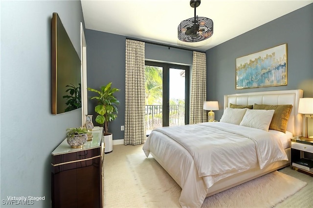 bedroom featuring access to outside, french doors, light colored carpet, and baseboards