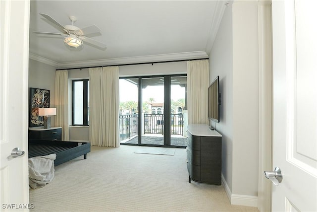 interior space with a ceiling fan, carpet flooring, crown molding, and baseboards