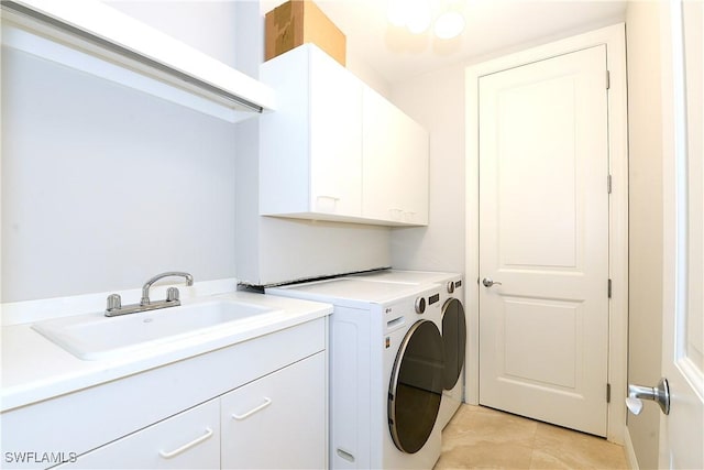 laundry room with separate washer and dryer, a sink, and cabinet space