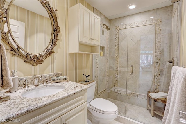 full bath featuring a stall shower, vanity, and toilet