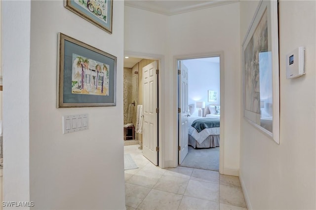 corridor with baseboards and light tile patterned floors