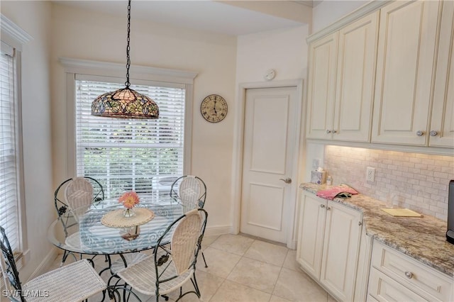 dining room featuring light tile patterned floors and baseboards