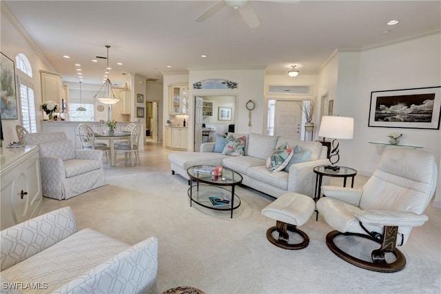 living area featuring ornamental molding, light colored carpet, and recessed lighting