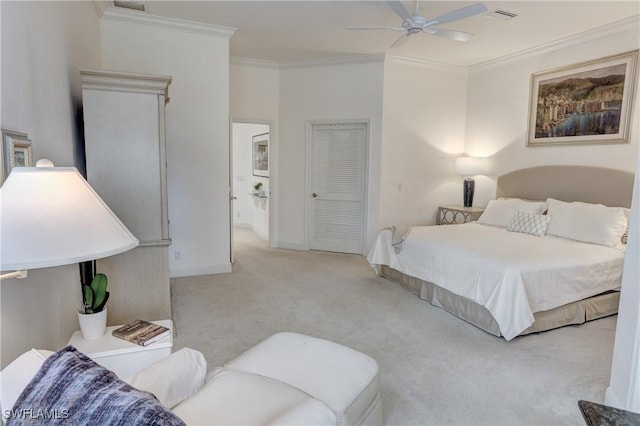 carpeted bedroom featuring a ceiling fan, baseboards, visible vents, and crown molding