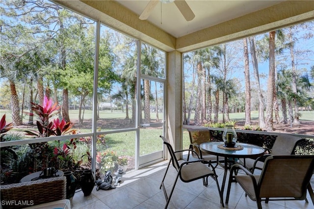 sunroom / solarium featuring ceiling fan