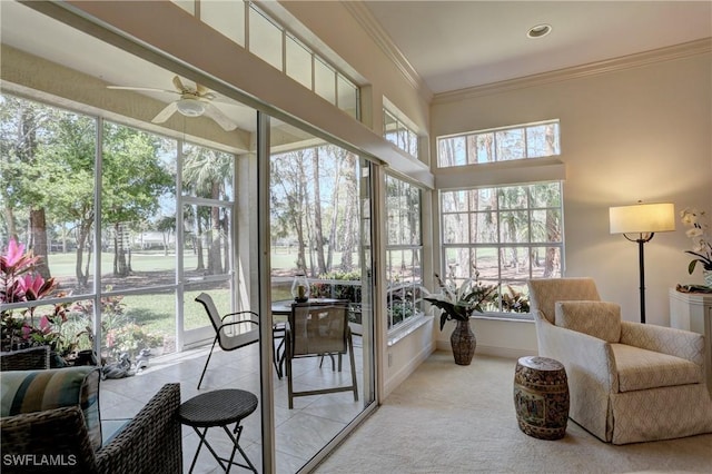 sunroom featuring a ceiling fan