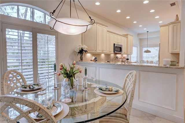 dining room featuring light tile patterned floors, recessed lighting, visible vents, and crown molding