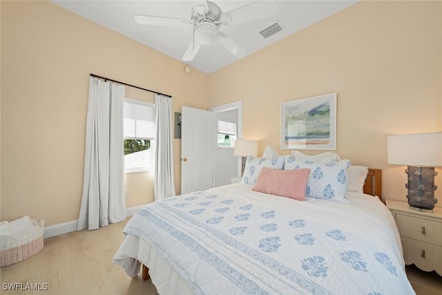 bedroom with light wood-type flooring, baseboards, visible vents, and ceiling fan