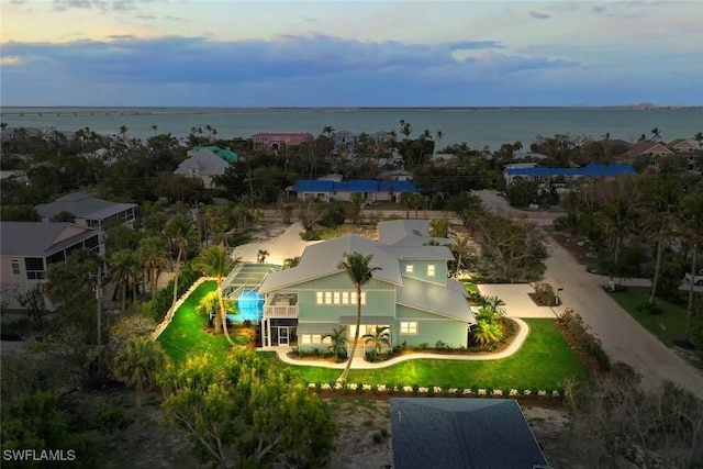 aerial view at dusk with a water view