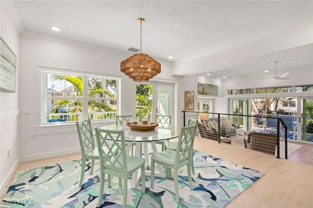 dining area featuring baseboards, visible vents, wood finished floors, crown molding, and recessed lighting