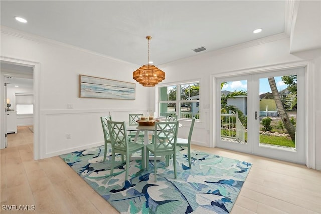 dining space with recessed lighting, visible vents, french doors, ornamental molding, and light wood-type flooring