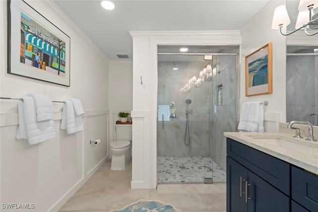 full bathroom featuring toilet, ornamental molding, a shower stall, vanity, and tile patterned floors