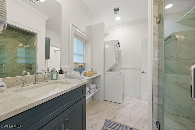 full bath with ornamental molding, stacked washer / drying machine, marble finish floor, and a stall shower