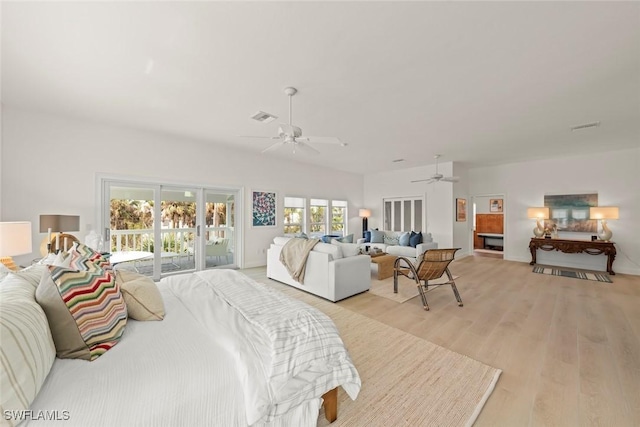 bedroom featuring light wood finished floors, access to outside, visible vents, and a ceiling fan