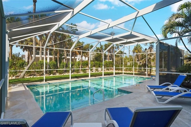 pool featuring a lanai and a patio area