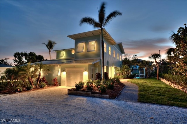 view of front of house featuring a front lawn and an attached garage