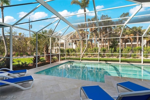 pool with a patio area and glass enclosure