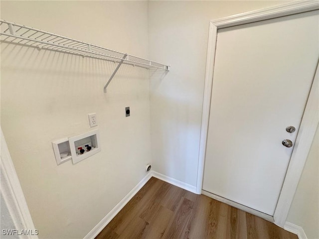 laundry area with washer hookup, dark wood-style flooring, electric dryer hookup, laundry area, and baseboards