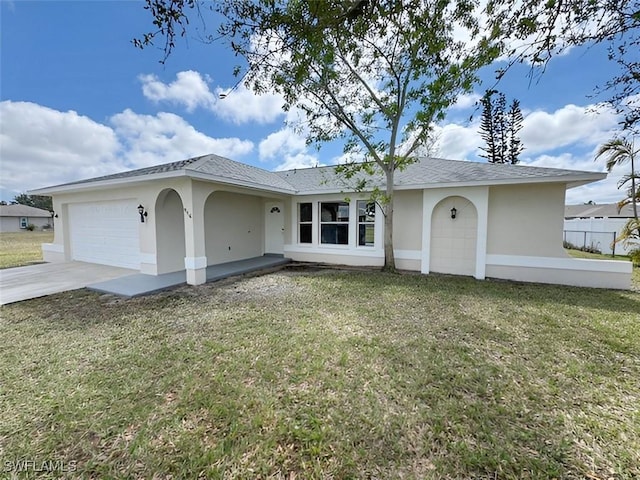 single story home featuring an attached garage, fence, concrete driveway, stucco siding, and a front lawn