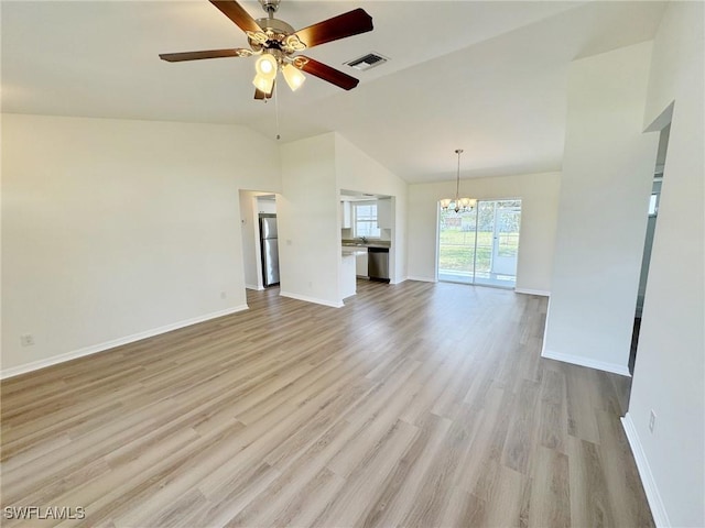 unfurnished living room with vaulted ceiling, light wood finished floors, visible vents, and baseboards