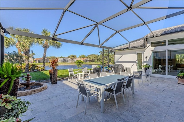 view of patio / terrace featuring a lanai and outdoor dining area