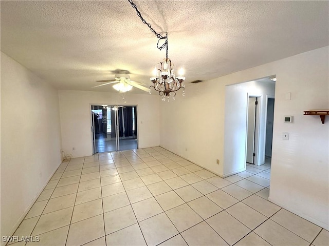 spare room featuring light tile patterned floors, visible vents, a textured ceiling, and ceiling fan with notable chandelier