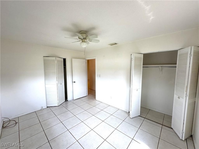 unfurnished bedroom with a ceiling fan, a closet, visible vents, and light tile patterned floors