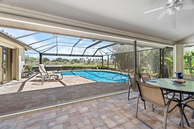 outdoor pool featuring a lanai, a ceiling fan, and a patio