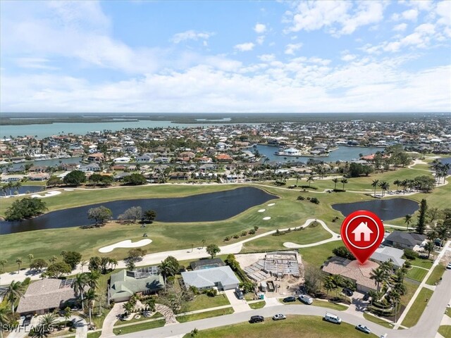 aerial view featuring view of golf course and a water view