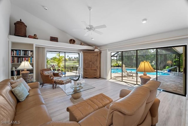 living room with light wood-style floors, a sunroom, a healthy amount of sunlight, and a ceiling fan