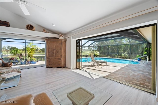 unfurnished living room with wood finished floors, a sunroom, and a healthy amount of sunlight