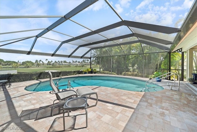 pool with a lanai and a patio area