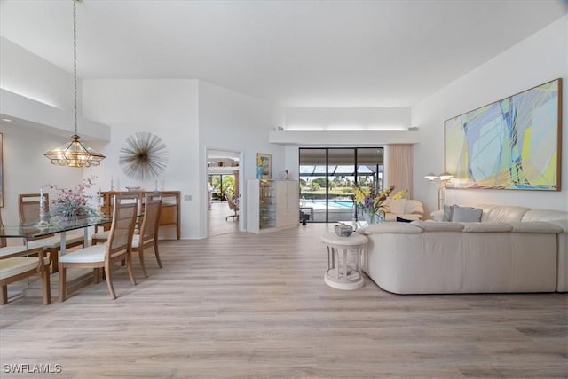 living room featuring a towering ceiling and wood finished floors