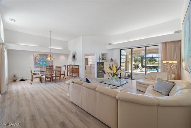 living room featuring light wood-type flooring and visible vents