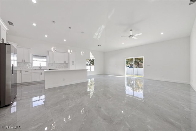 unfurnished living room with baseboards, a ceiling fan, marble finish floor, a sink, and recessed lighting