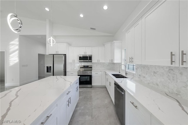 kitchen with backsplash, white cabinetry, stainless steel appliances, and a sink