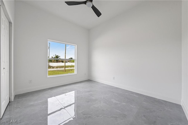 unfurnished room featuring ceiling fan, lofted ceiling, and baseboards