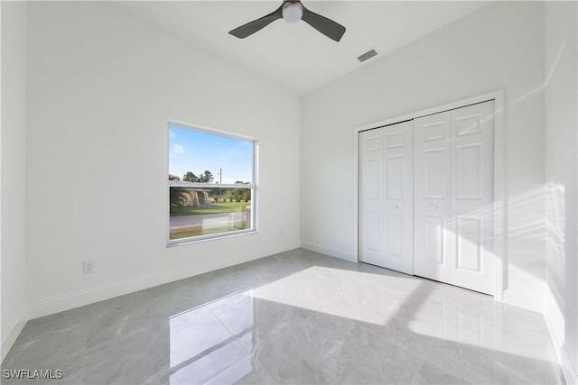 unfurnished bedroom featuring baseboards, visible vents, ceiling fan, and a closet