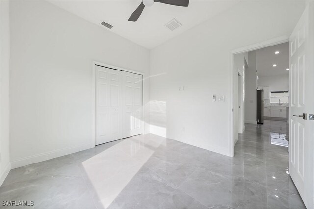 unfurnished bedroom featuring baseboards, visible vents, and a closet