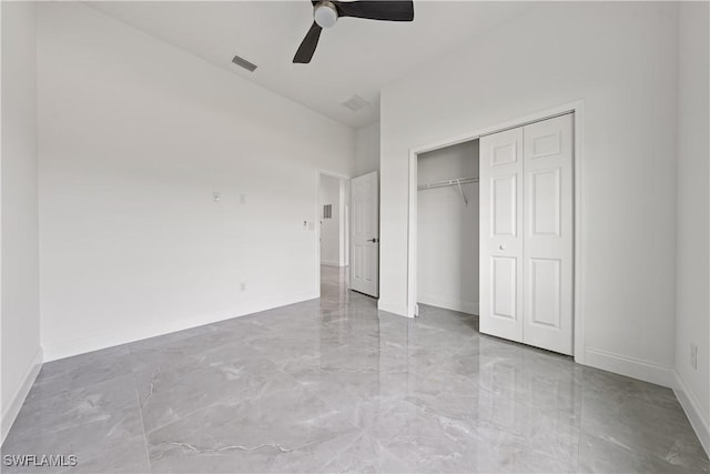 unfurnished bedroom with marble finish floor, a closet, visible vents, a ceiling fan, and baseboards