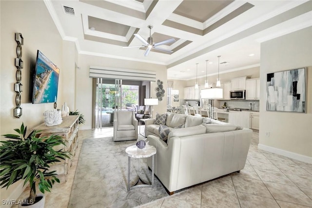 living room with light tile patterned floors, visible vents, coffered ceiling, ceiling fan, and crown molding