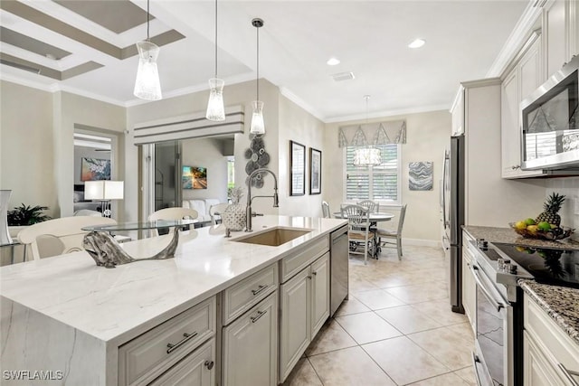 12121 Chrasfield Chase, Fort Myers, FL 33913 - kitchen featuring appliances with stainless steel finishes, an island with sink, decorative light fixtures, light stone counters, and ornamental molding