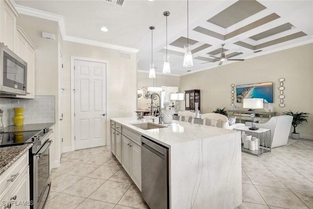 kitchen with tasteful backsplash, coffered ceiling, stainless steel appliances, crown molding, and light tile patterned flooring